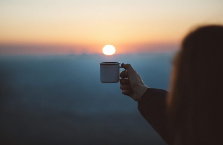 Person Showing White Mug in Focus Photography