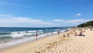Beautiful sandy beach in Virginia with ocean waves, blue sky, and families enjoying a relaxing summer day on the coast